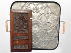 An embossed metal twin handled serving tray, width 71 cm,