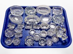 A group of antique pressed glass salts and other dishes.