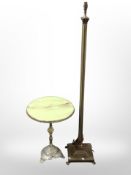 An onyx circular occasional table and a brass standard lamp
