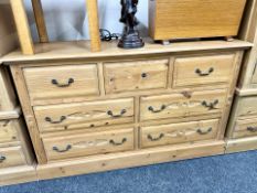 A carved pine seven drawer chest,