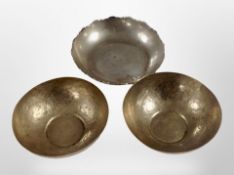 A pair of Middle Eastern white metal bowls, and a further example.