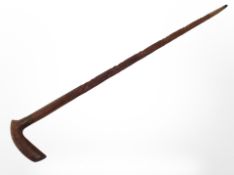 A carved wooden walking stick, length 94cm.