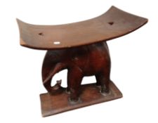 A carved hardwood elephant stool,