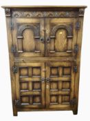 A reproduction panelled oak cabinet,