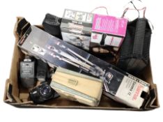 A box containing Praktica camera, camera tripod, boxed vice, battery charger, vintage radio, etc.