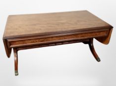 A reproduction mahogany and burr walnut drop leaf coffee table,