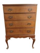 A burr walnut chest of four drawers on cabriole legs,