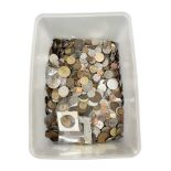 A large plastic tub containing a quantity of world coins.