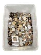 A large plastic tub containing a quantity of world coins.