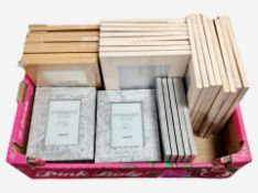 A box of new Fotolijst rustic picture frames in various sizes.