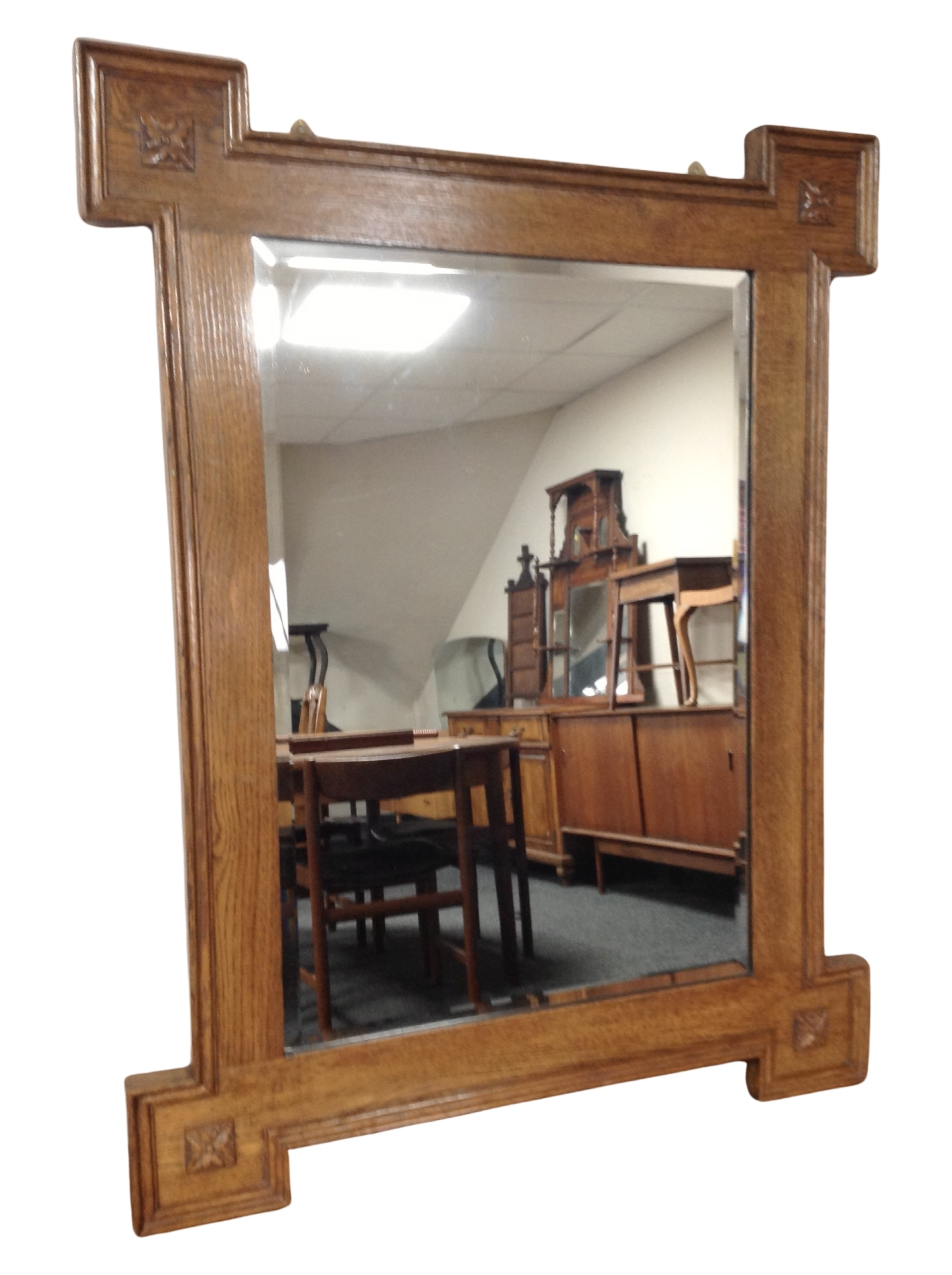 A carved oak bevelled overmantel mirror, 90cm x 70cm.