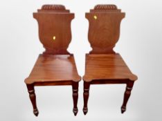 A pair of Victorian mahogany hall chairs