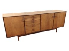 A G-Plan teak low sideboard, fitted cupboards and drawers,