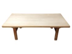 A blonde oak rectangular coffee table,
