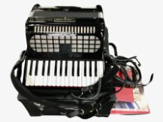 A Chamoon piano accordion in carry case.