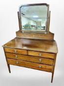 A late Victorian mahogany and satin wood inlaid mirror backed four drawer dressing table,