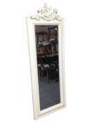 A reproduction mirror decorated with cherubs,