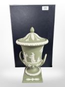 A Wedgwood green Jasperware twin-handled lidded urn, height 29cm, boxed.