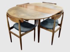 A Dalescraft teak extending dining table with leaves total length 200 cm,