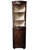 A reproduction mahogany bow-front corner cabinet,