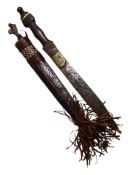 An African dagger in decorative leather sheath, length 43cm.