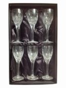 A boxed set of six Royal Doulton crystal champagne glasses.