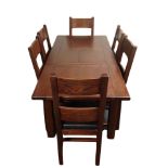 A contemporary stained oak extending dining table,