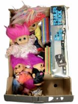 A box containing Beatrix Potter volumes, dolls, remote-control trailer truck.