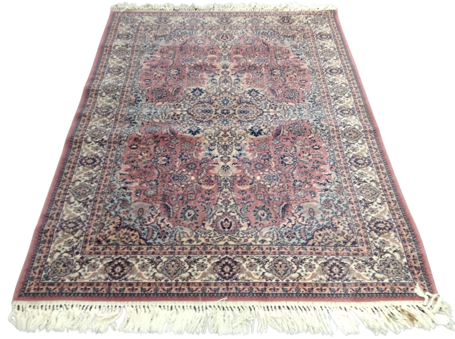 A machine made rug of Persian design,