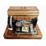 A Frister & Rossmann hand sewing machine in walnut case