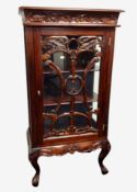 A Victorian style carved hardwood display cabinet on cabriole legs,