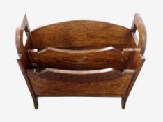 A reproduction carved oak magazine rack,