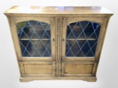 A reproduction leaded glass door oak cabinet,