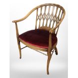 A beech open armchair with carved lattice back rest,