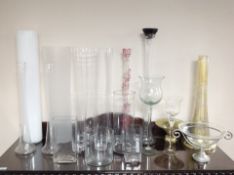A collection of glass flower arranging vases