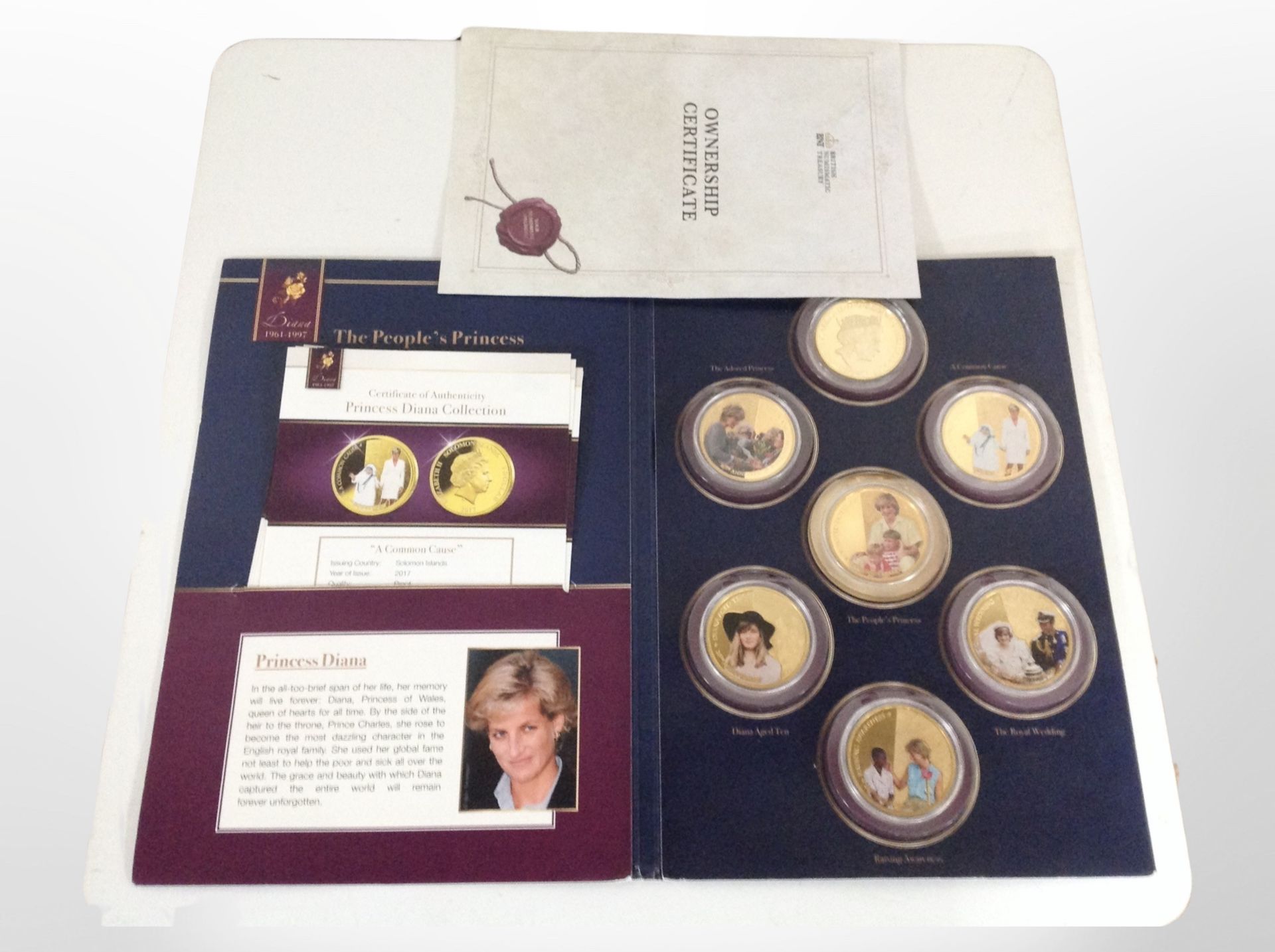 A set of seven gold-plated $1 coins commemorating Princess Diana, with certificate. - Image 2 of 2