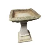 A concrete pedestal bird bath,