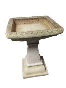 A concrete pedestal bird bath,