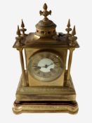 A gilt brass eight day mantel clock on gilt and red velvet-topped plinth, overall height 38cm.