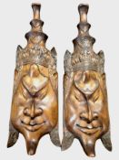 A pair of South-East Asian carved hardwood wall masks, length 51cm.
