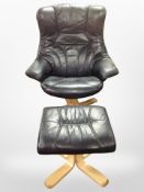 A contemporary black stitched leather swivel armchair on beech support with matching footstool