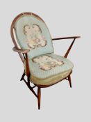 An Ercol stained elm spindle back armchair