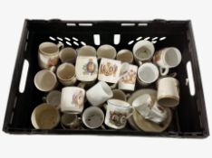 A crate containing a quantity of royal commemorative mugs.