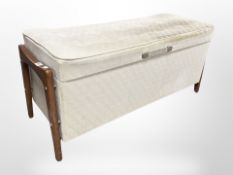A 20th century upholstered teak storage ottoman,