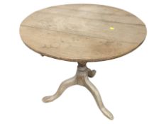 A 19th century oak tripod table,