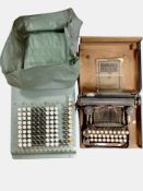 A vintage adding machine and a Corona typewriter in box