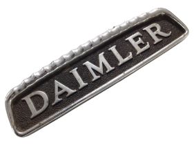 A die cast metal Daimler badge,