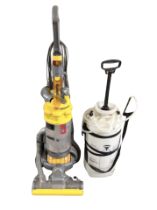 A Dyson upright vacuumn cleaner and a 16 litre water pump