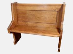 A Victorian pitch pine pew with painted sides,