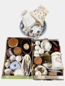 Two crates and a basket of assorted ceramics, cutlery, lamp bases, etc.